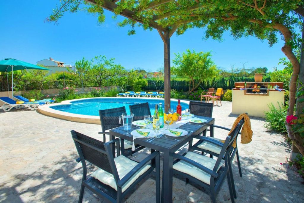 Holiday villa to rent in Puerto Pollensa with outside seating under a terrace and a private pool.